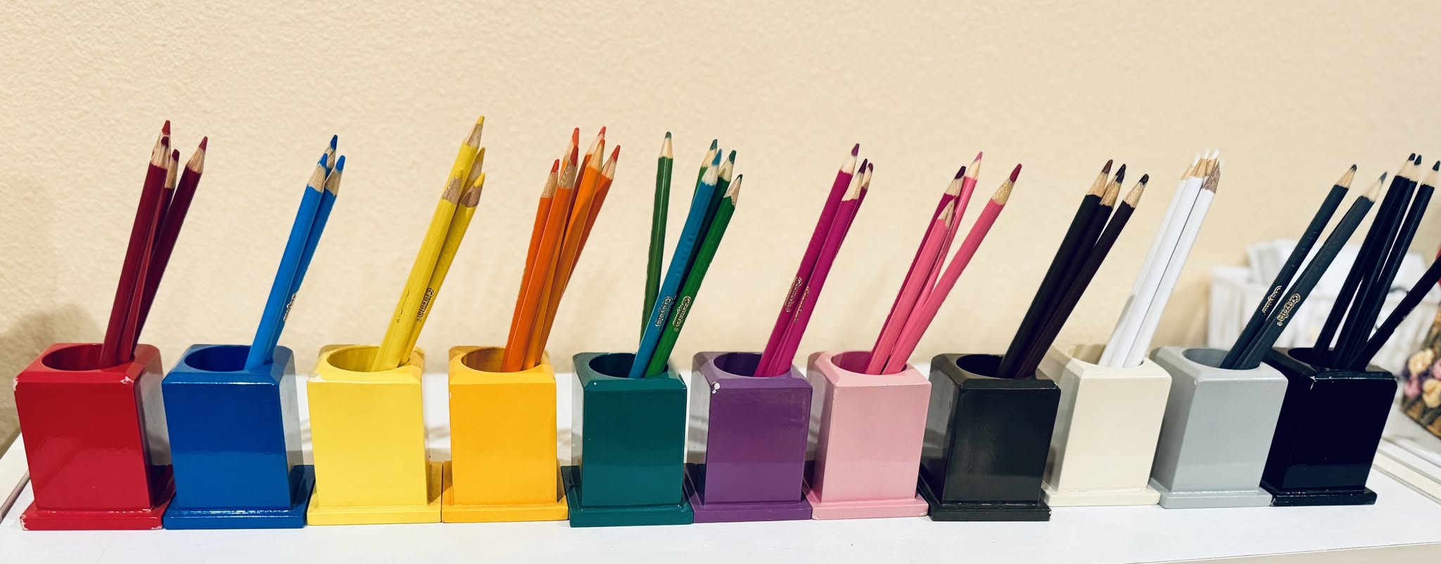 Montessori colored pencil holders arranged by color